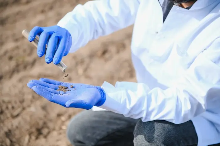 Technician testing soil in the field